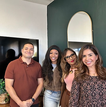 Four people standing together after a session.