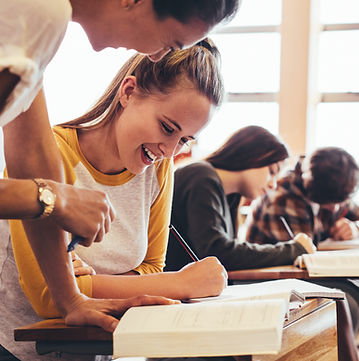 Students working at their desks in a classroom.